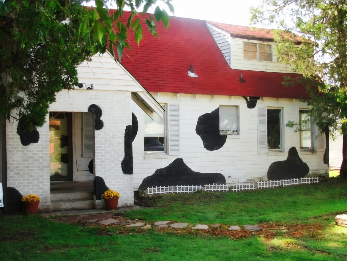 1023 College Avenue, The Cow House: white house with black spots and a red roof
